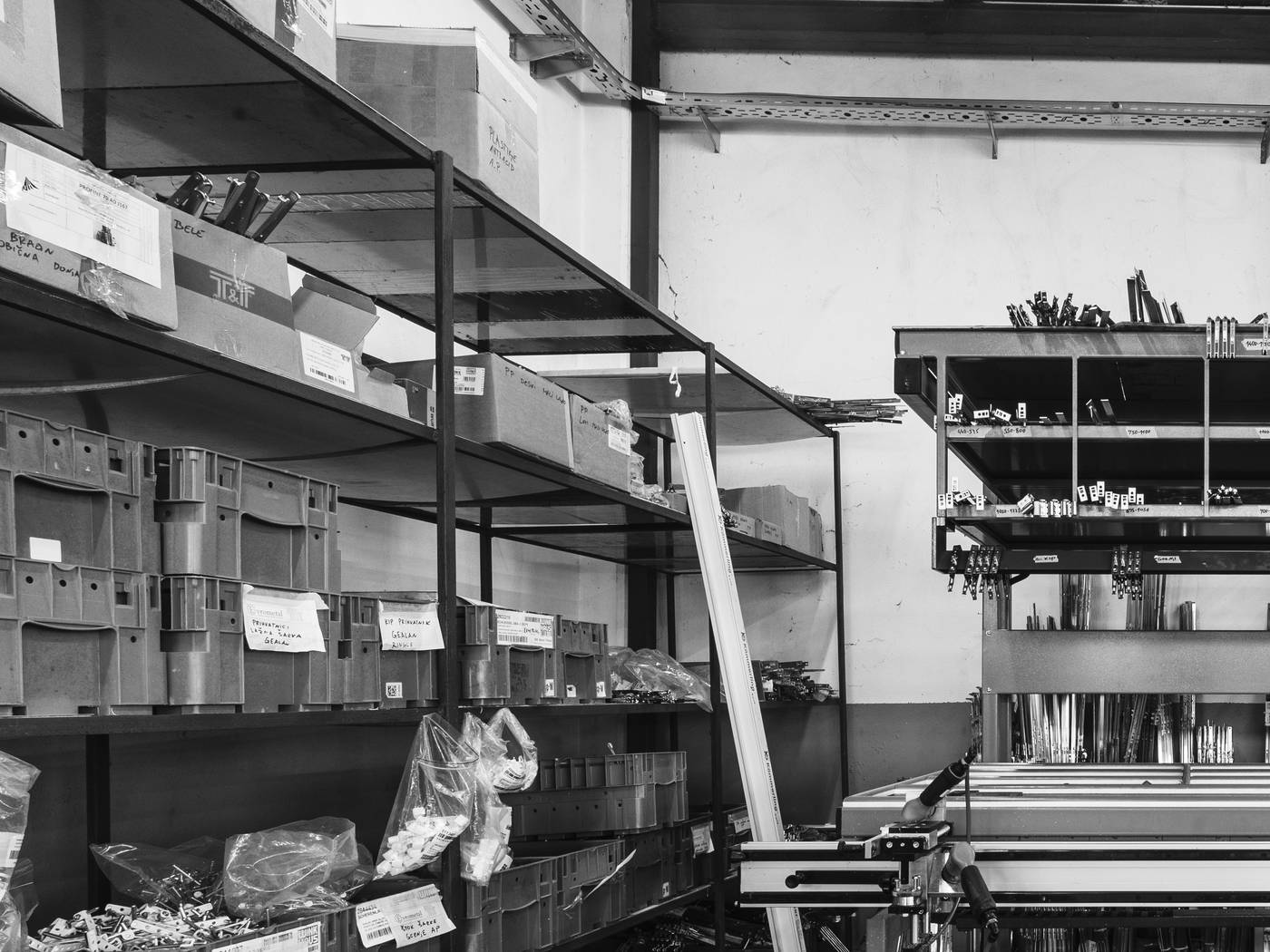 Metal fabrication workshop with component storage and forming equipment